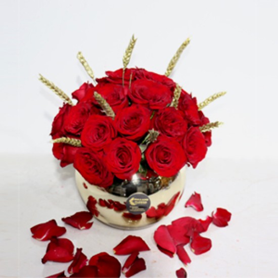 Golden vase with red rose